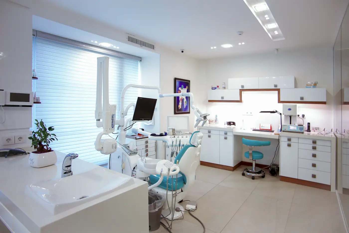 Clean, modern dental treatment room with chair and equipment